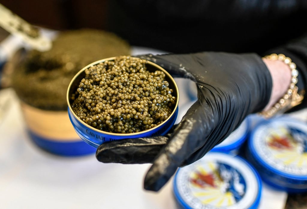 A staff member at a luxury food shop puts caviar in a box. Photo: AFP