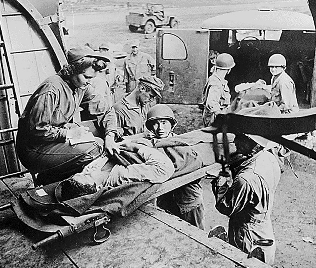 A US Army nurse takes the name of a wounded soldier as he is evacuated from Guadalcanal during World War II. Photo: AFP A US Army nurse takes the name of a wounded soldier as he is evacuated from Guadalcanal during World War II. Photo: AFP