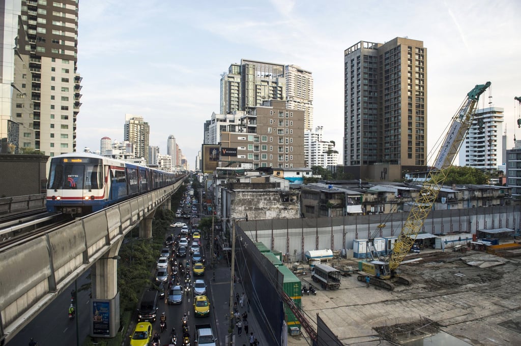 A suburban train passes a building construction site in central Bangkok in this file photo from December 4, 2018. Photo: AFP A suburban train passes a building construction site in central Bangkok in this file photo from December 4, 2018. Photo: AFP