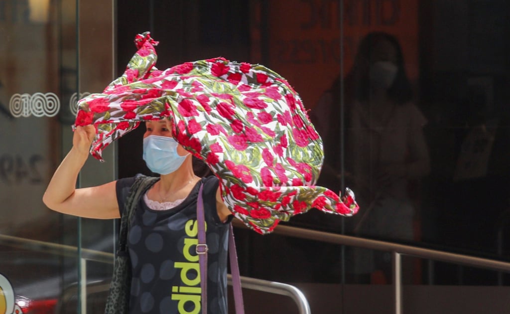 A pedestrian sought shelter from the heat wave in Hong Kong’s Kwun Tong district on 8 July 2022. Photo: Xiaomei Chen