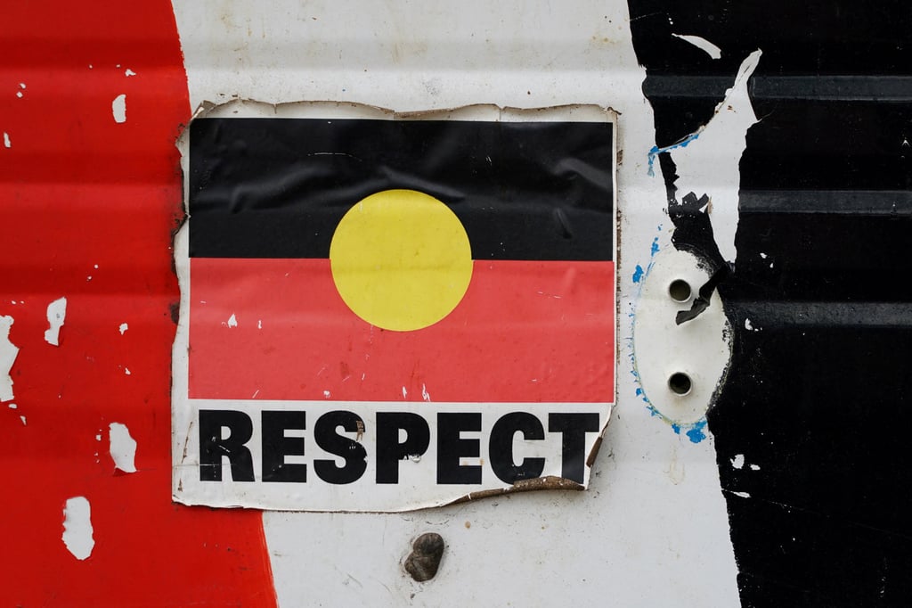 A sticker of the Australian Aboriginal Flag along with the word “RESPECT” is pictured on a structure at the Aboriginal Tent Embassy, a site of protest since 1972, in Canberra, Australia. Photo: Reuters/File