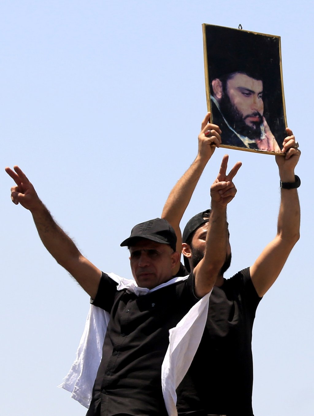 Supporters of Iraqi Shiite cleric Muqtada al-Sadr, head of the Sadrist movement, carry his picture’ in central Baghdad, Iraq on Saturday. Photo: EPA-EFE