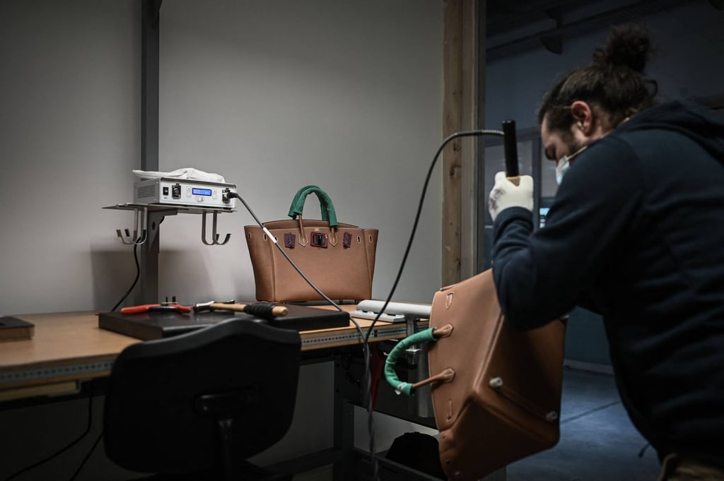 An employee working on a leather handbag at the leather goods workshop of French high fashion luxury goods manufacturer Hermès in Montbron, some 28 kms East of Angouleme, on January 6. Photo: AFP