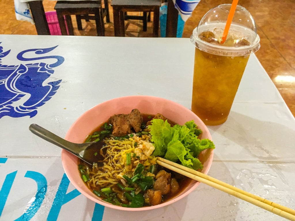 A bowl of noodles in a broth of pork and longan, with longan fruit. Photo: Ron Emmons