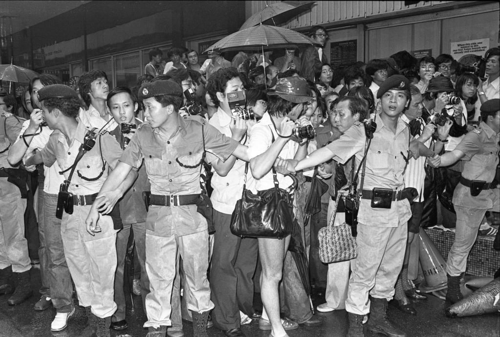 The scene outside the building with police keeping the crowds back. Photo: SCMP