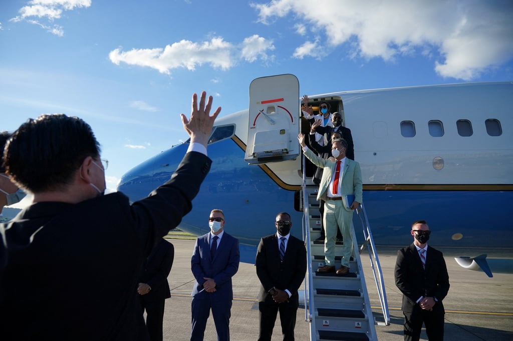Taiwan Foreign Minister Joseph Wu waves at US House Speaker Nancy Pelosi and other delegation members as they board a plane before leaving Taipei on Wednesday. Photo: Taiwan Ministry of Foreign Affairs via Reuters