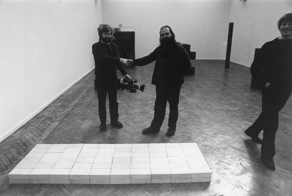 American minimalist artist Carl Andre (centre) with his artwork Equivalent VIII, made from 120 fire bricks, at the Whitechapel Gallery in London in 1978. Photo: Getty Images American minimalist artist Carl Andre (centre) with his artwork Equivalent VIII, made from 120 fire bricks, at the Whitechapel Gallery in London in 1978. Photo: Getty Images
