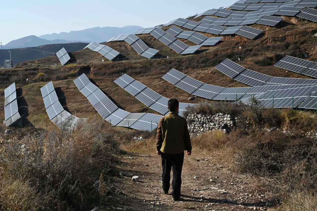A person walks near solar panels in Huangjiao village in Baoding in China’s northern Hebei province on October 23, 2021. Solar panels equal to 250 gigawatts of power production will be retired by 2040 in China. Photo: AFP A person walks near solar panels in Huangjiao village in Baoding in China’s northern Hebei province on October 23, 2021. Solar panels equal to 250 gigawatts of power production will be retired by 2040 in China. Photo: AFP