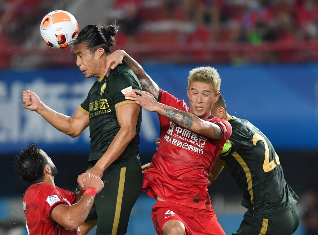 Zhang Yuning of Beijing Guoan vies for the ball with Luo Xin of Henan during their Chinese Super League match in Zhengzhou. Photo: Xinhua