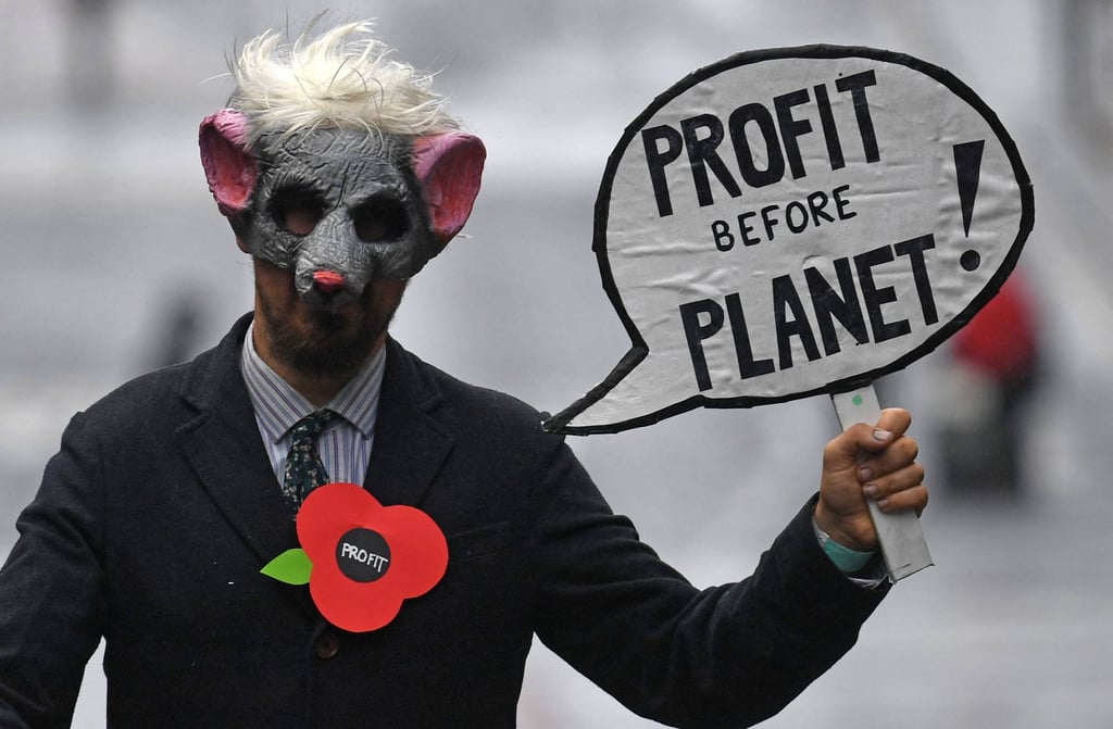 A demonstrator holds a placard at a rally in Glasgow, UK, on November 6, 2021, during the COP26 UN Climate Change Conference. Photo: AFP A demonstrator holds a placard at a rally in Glasgow, UK, on November 6, 2021, during the COP26 UN Climate Change Conference. Photo: AFP