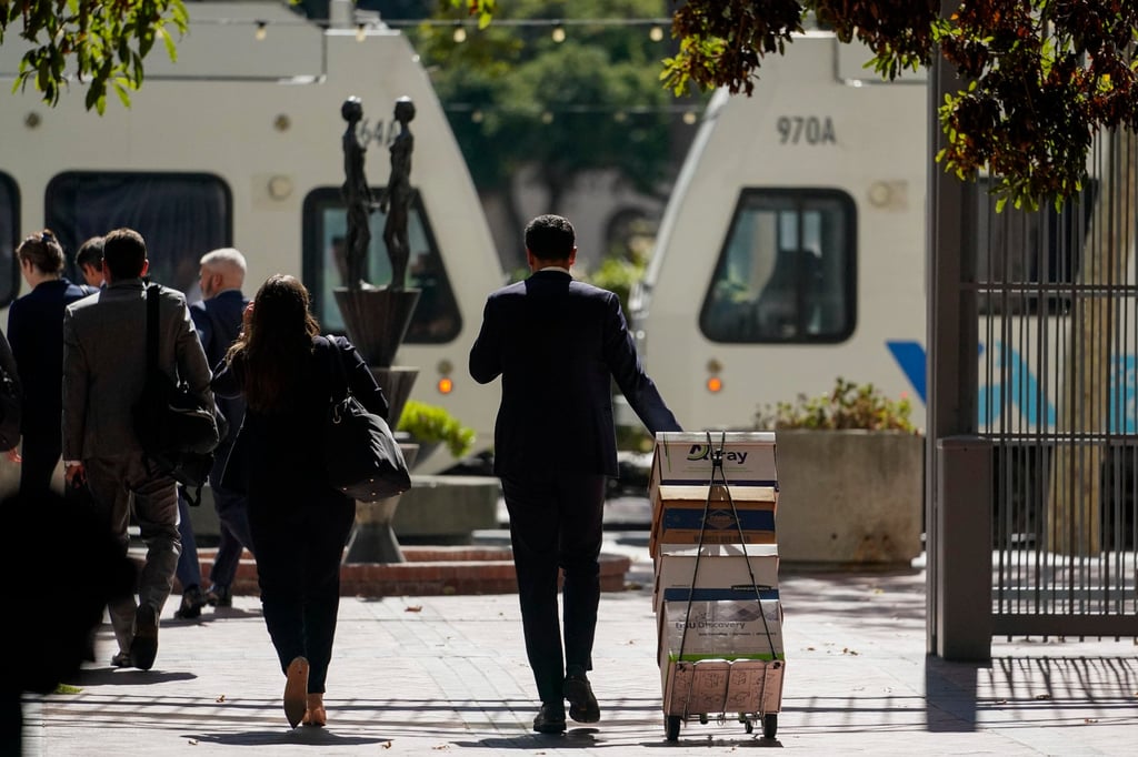 A stack of boxes is wheeled away by the team of lawyers representing the PGA Tour outside a federal courthouse in San Jose. Photo: AP
