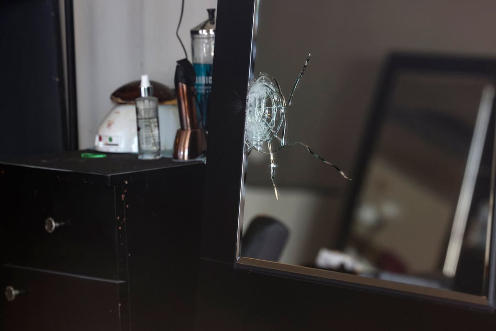 A shattered mirror inside Hair World Salon in Dallas after a shooting incident in May. Photo: The Dallas Morning News via AP