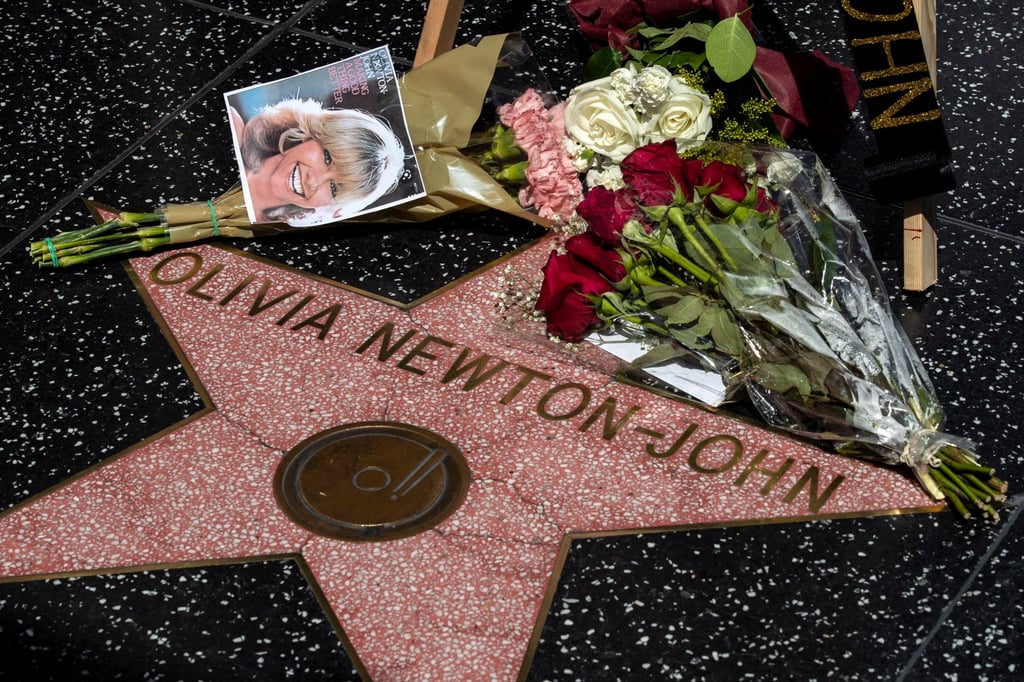Flowers and photos displayed next to the star of Australian singer and actress Olivia Newton-John on the Hollywood Walk of Fame after news broke of her death on August 8. Photo: EPA-EFE Flowers and photos displayed next to the star of Australian singer and actress Olivia Newton-John on the Hollywood Walk of Fame after news broke of her death on August 8. Photo: EPA-EFE