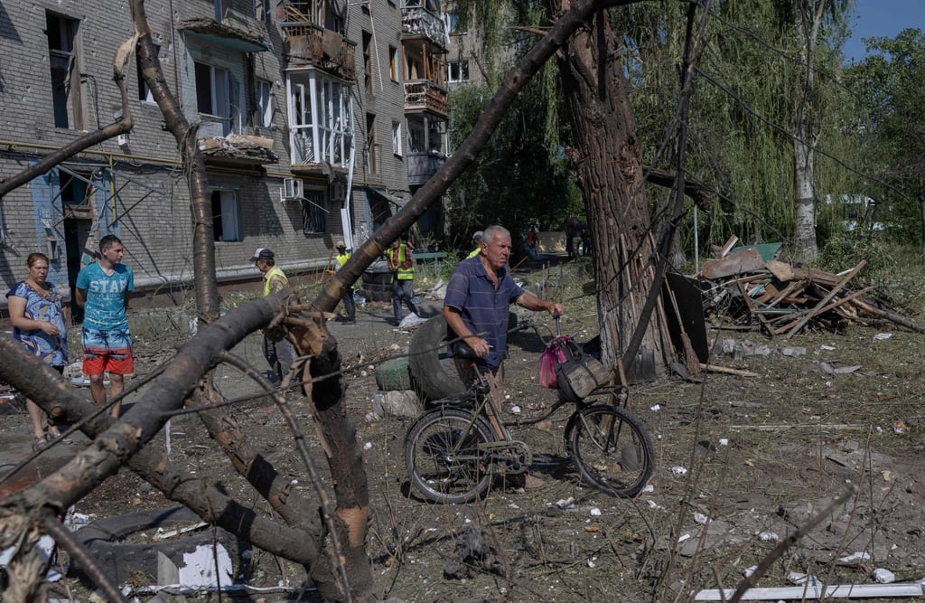 A man pushes his bike past a destroyed building in Sloviansk, eastern Ukraine, on July 29. Photo: AFP
