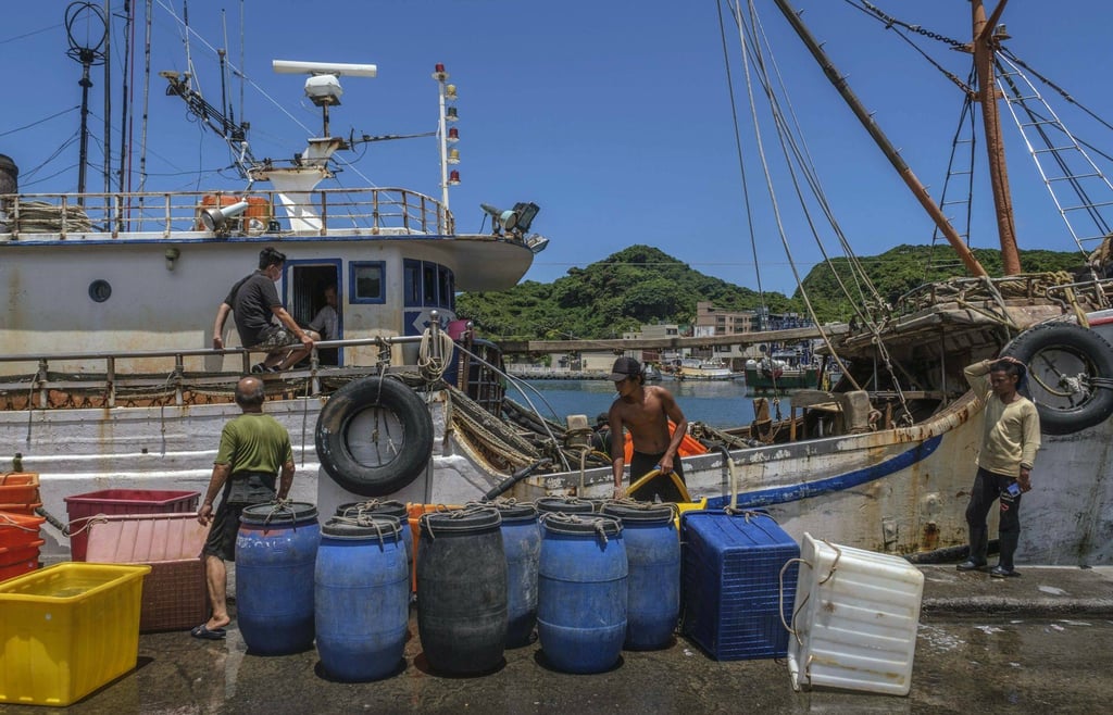 Workers clean a fishing boat at a harbour in Keelung, Taiwan, on August 4. Beijing began conducting military exercises around the island following Nancy Pelosi’s visit. Photo: Bloomberg