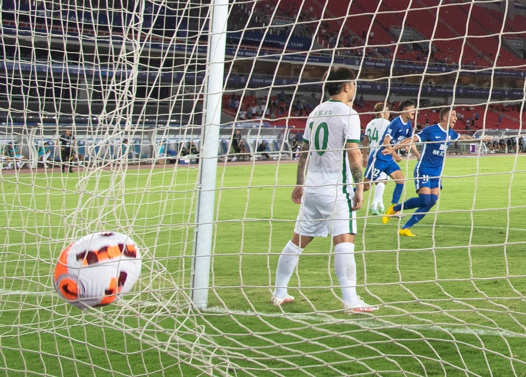 Davidson (right) of Wuhan Three Towns scores against Beijing Guoan.