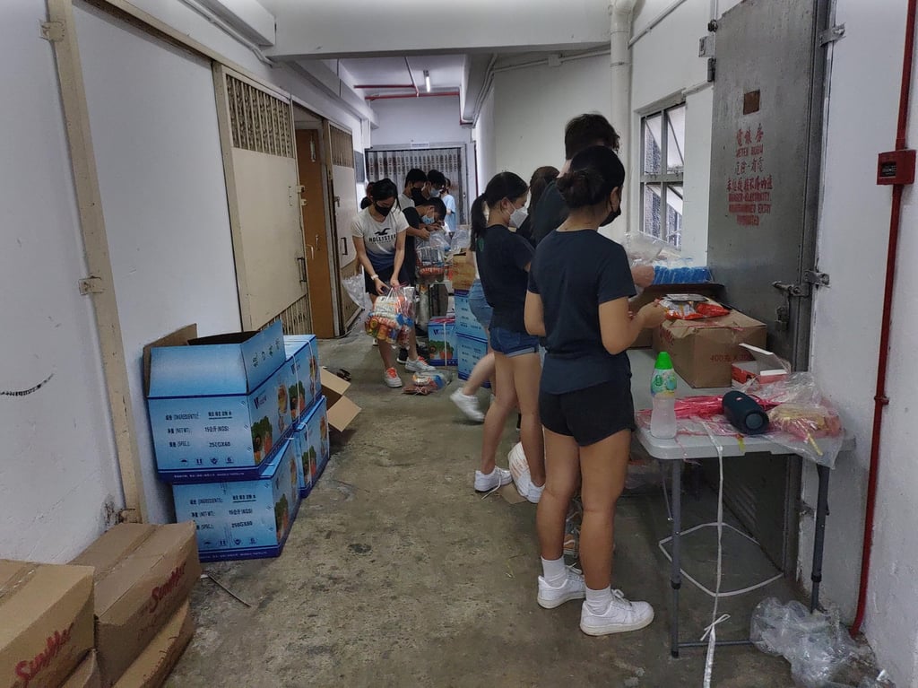 Volunteers pack food bags to be delivered to care homes for elderly residents and community development centres across Hong Kong. Photo: Handout Volunteers pack food bags to be delivered to care homes for elderly residents and community development centres across Hong Kong. Photo: Handout