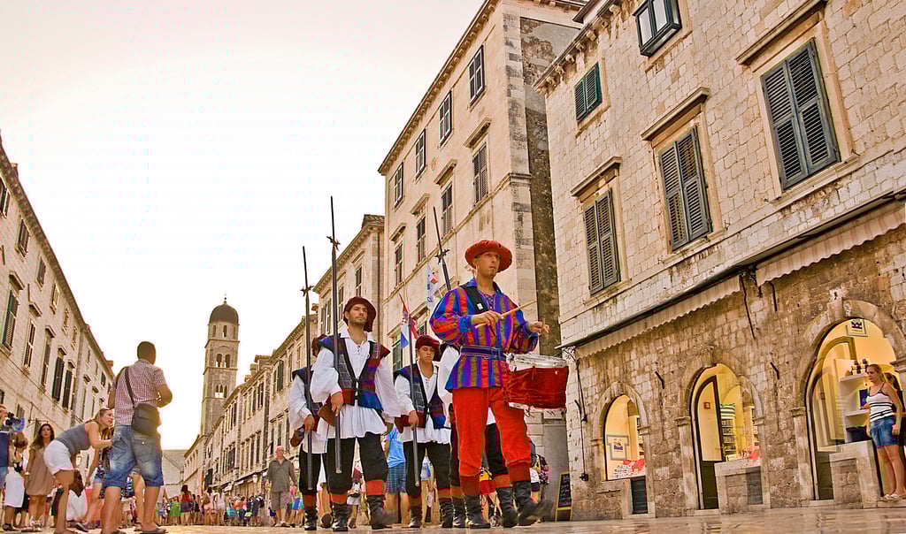Tourists photograph ceremonial drummers and guards in Dubrovnik. Photo: Tim Pile