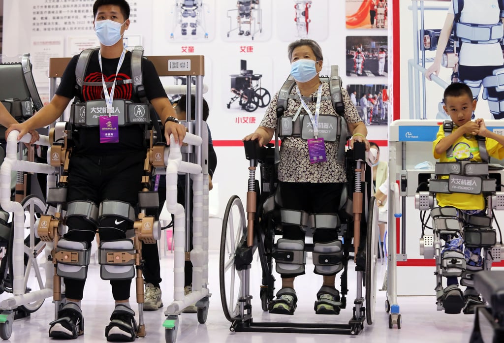 Visitors at the opening of the World Robot Conference 2022 in Beijing on August 18, 2022, are seen testing artificial intelligence-powered robotic walkers that can assist people who have difficulty walking. Photo: Simon Song Visitors at the opening of the World Robot Conference 2022 in Beijing on August 18, 2022, are seen testing artificial intelligence-powered robotic walkers that can assist people who have difficulty walking. Photo: Simon Song