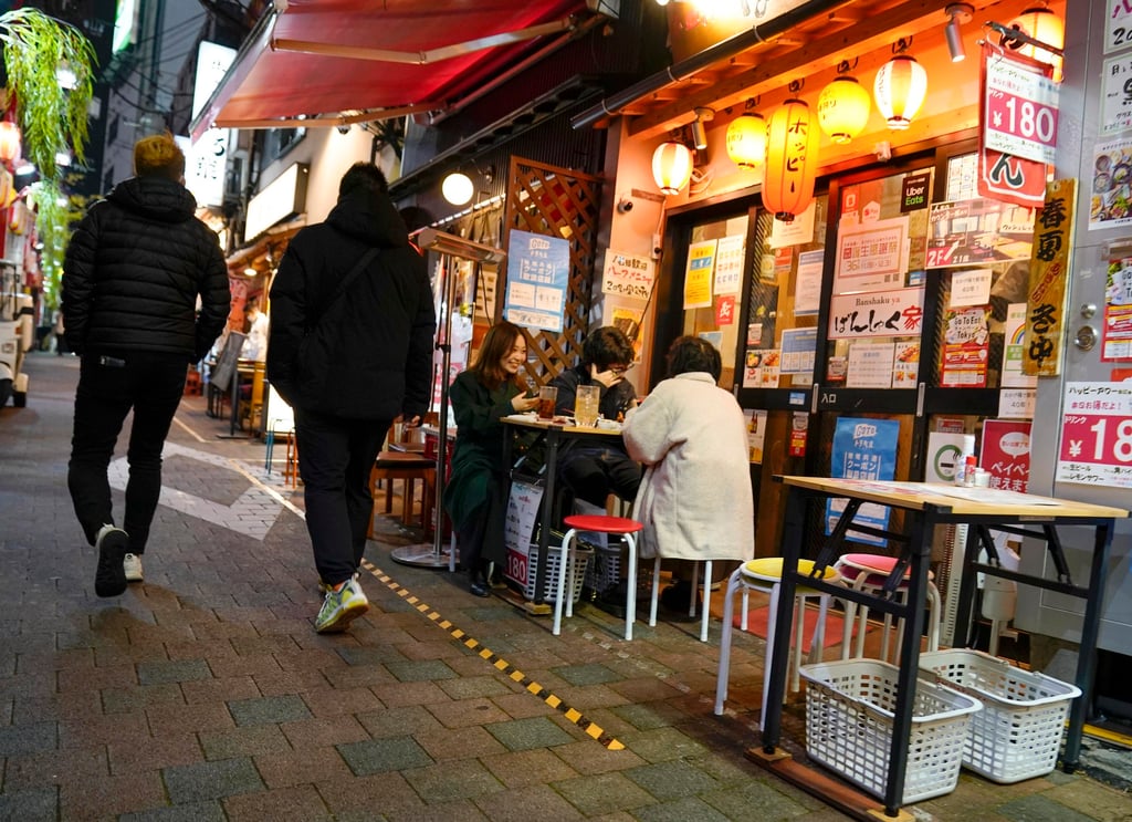 Visitors walk through a tiny drinking street in Shinjuku, Tokyo. Consumption of sake has been falling for years in Japan. Photo: EPA-EFE