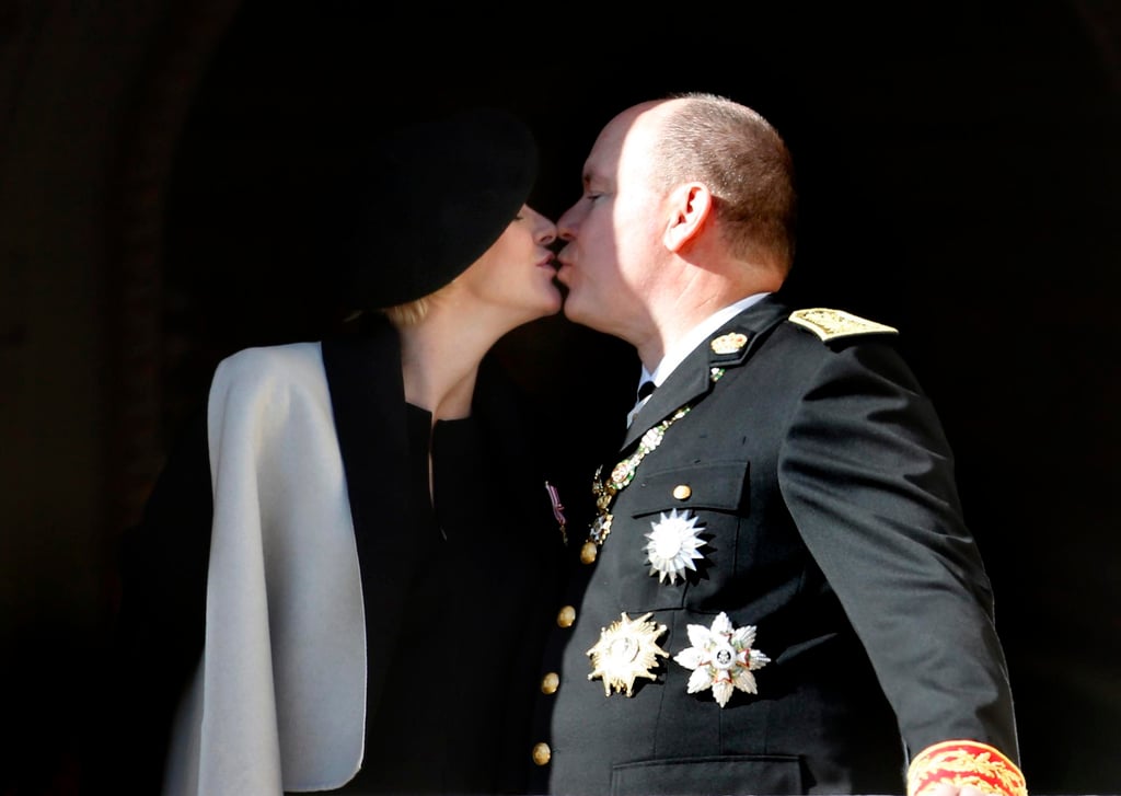 Monaco’s Prince Albert and his wife, Princess Charlene kiss as they attend the Army Parade, as part of the official ceremonies for the Monaco National Day in Monte Carlo, Monaco, in November 2014. Photo: EPA