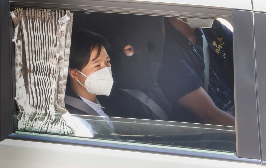 Quinn Moon (hooded) has spent the past two years behind bars on the mainland. Photo: Dickson Lee