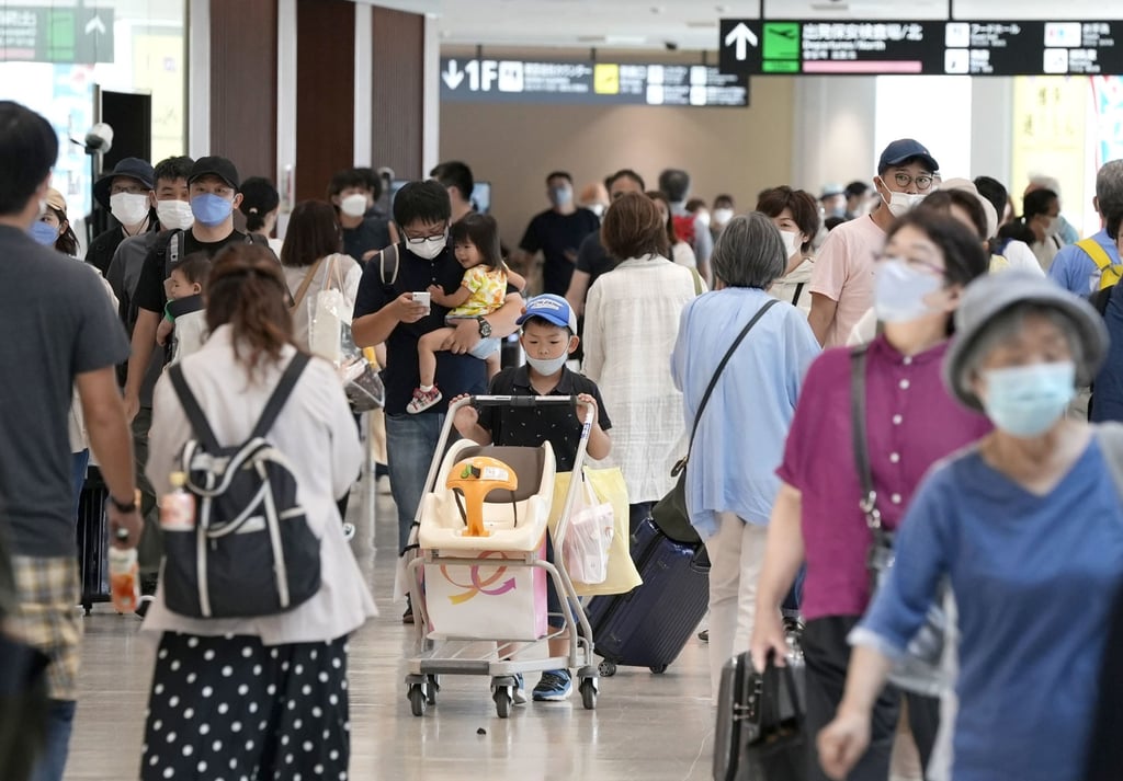 Travellers walk through a crowded lobby in Fukuoka airport, southwestern Japan, earlier this month. Photo: Kyodo Travellers walk through a crowded lobby in Fukuoka airport, southwestern Japan, earlier this month. Photo: Kyodo