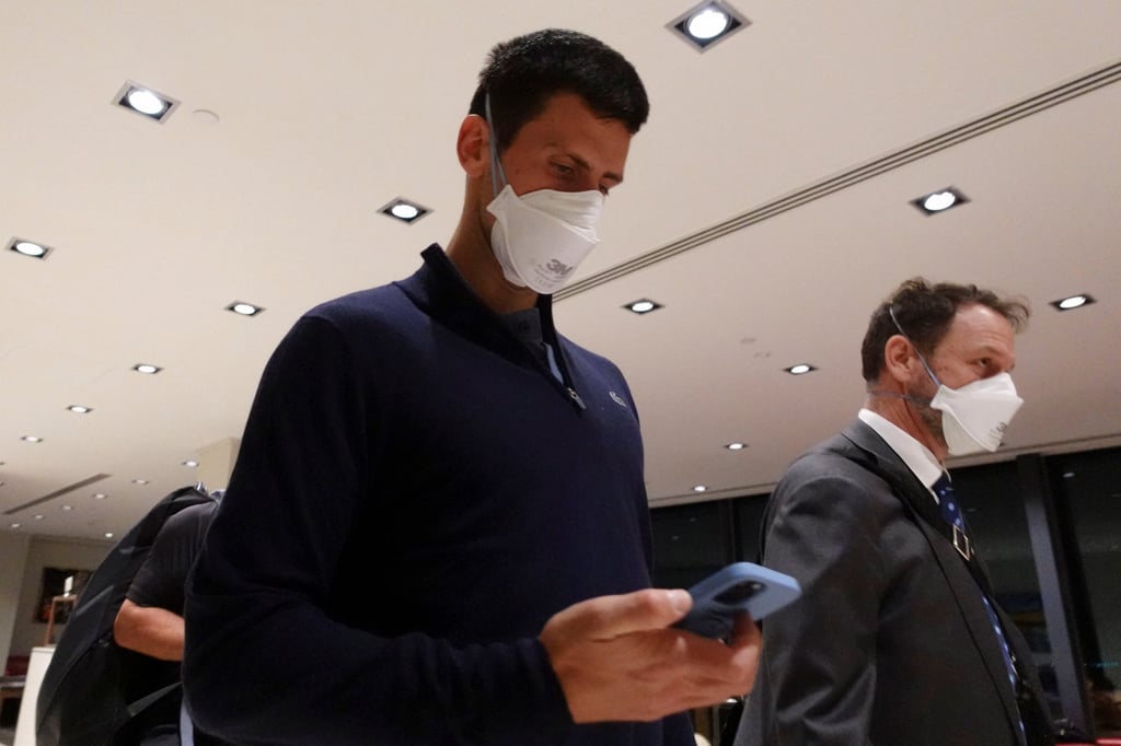Djokovic walks through Melbourne Airport before boarding a flight after the Federal Court upheld a government decision to cancel his visa to play in the Australian Open. Photo: Reuters