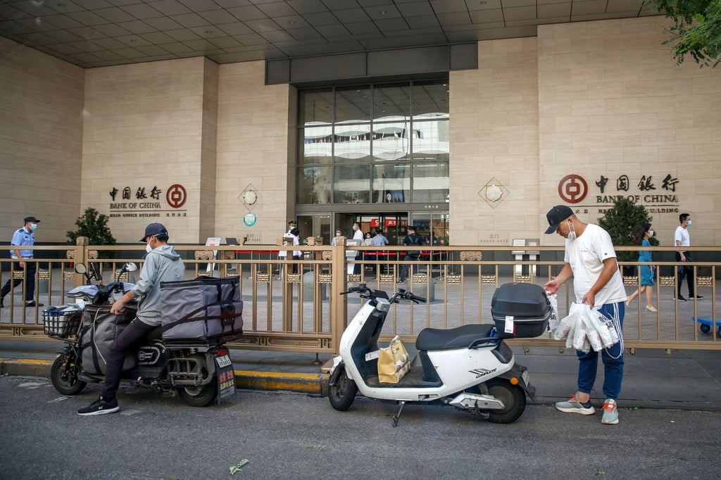 Delivery riders arrive outside a Bank of China branch in Beijing on August 22. China has cut benchmark loan rates in an attempt to revive its flagging economy. Photo: EPA-EFE Delivery riders arrive outside a Bank of China branch in Beijing on August 22. China has cut benchmark loan rates in an attempt to revive its flagging economy. Photo: EPA-EFE