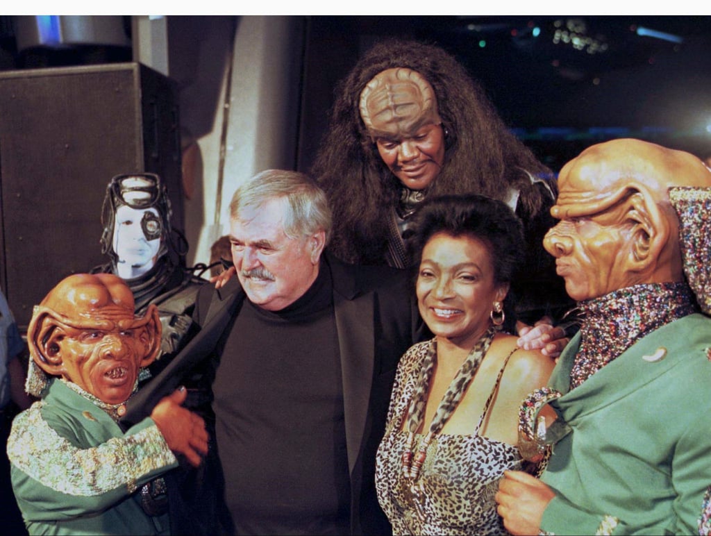From left, a Ferengi moves for James Doohan’s wallet as he poses with Nichelle Nichols and other Star Trek characters in 1998. Photo: Reuters