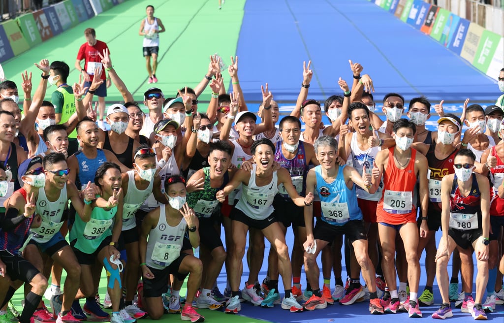 Delighted runners arrive at the finish in Victoria Park of the 2021 Hong Kong Marathon. Photo: Nora Tam
