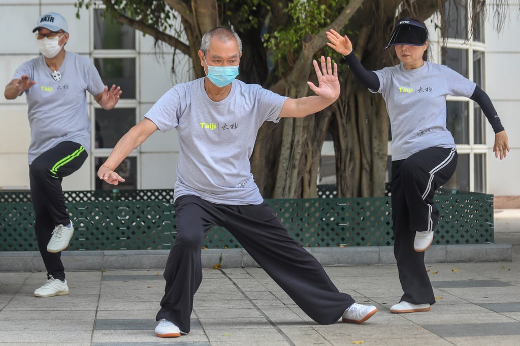 People wearing a face mask practice Tai Chi at Kowloon Park in Tsim Sha Tsui. Hong Kong has stricter social distancing measures than many other countries. Photo: Xiaomei Chen