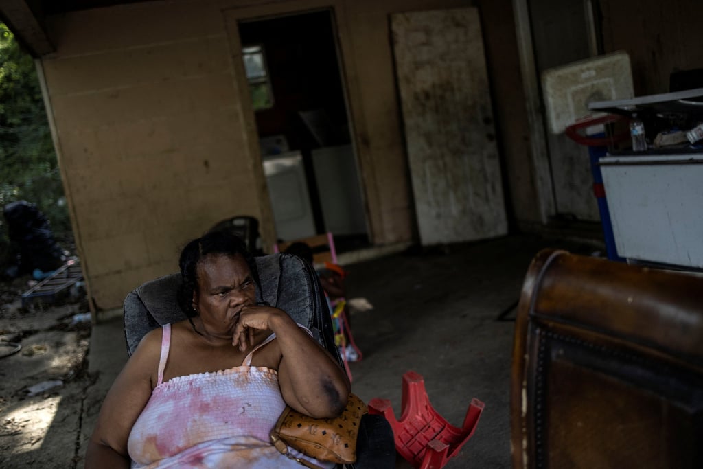 A local resident sits outside her house as the city of Jackson is to go without reliable drinking water indefinitely. Photo: Reuters