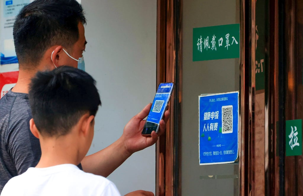 A man scans a QR code for monitoring Covid-19 outside a shop in Zhengzhou, Henan province, on June 17. Photo: AP