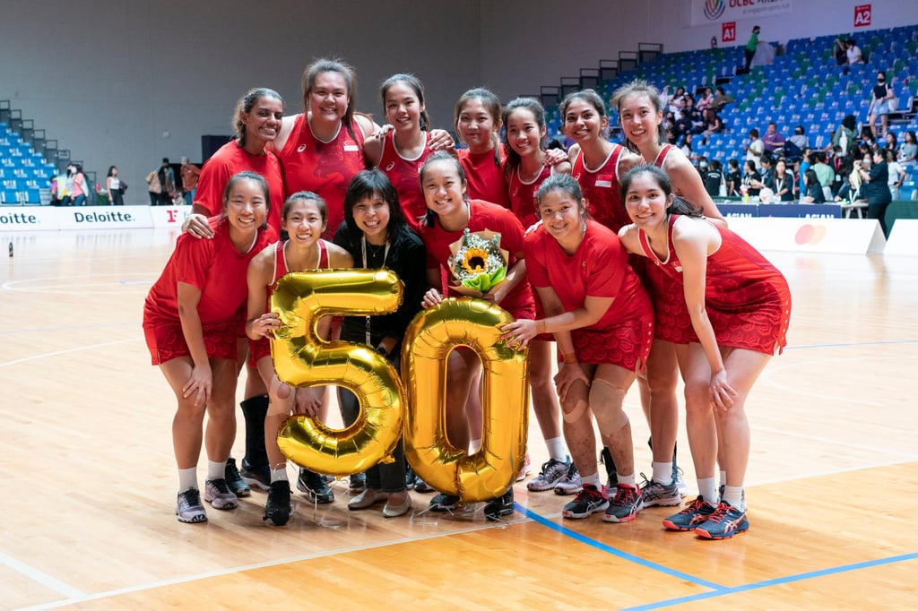 The Singapore team celebrate co-captain Toh Kai Wei winning her 50th international cap after the game against Hong Kong in the Asian Netball Championships. Photo: Netball Singapore The Singapore team celebrate co-captain Toh Kai Wei winning her 50th international cap after the game against Hong Kong in the Asian Netball Championships. Photo: Netball Singapore