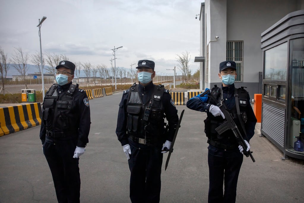 Police officers stand outside Urumqi No 3 Detention Center in western China’s Xinjiang Uygur autonomous region. Photo: AP Police officers stand outside Urumqi No 3 Detention Center in western China’s Xinjiang Uygur autonomous region. Photo: AP