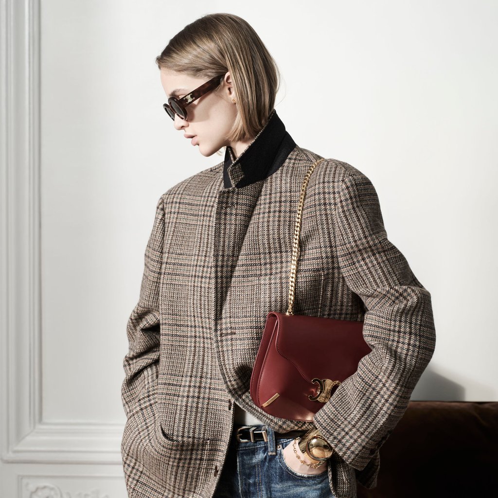 Highlights from the Celine autumn 2022 collection include oversized tailored blazers and bags like the Chain Besace Triomphe in shiny carmine calfskin.