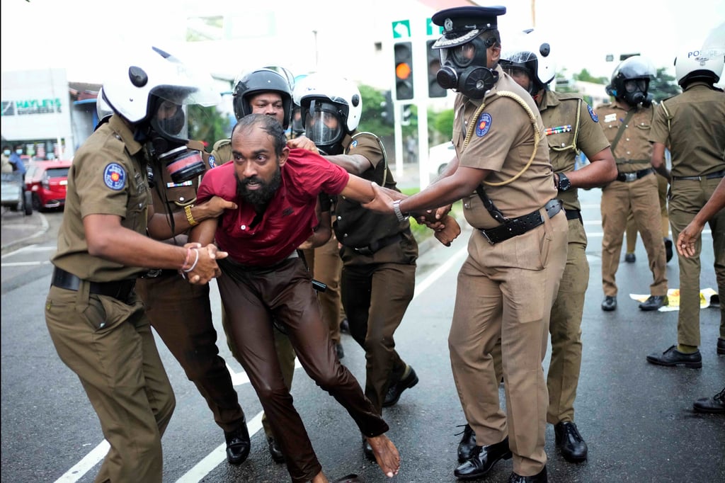 Sri Lankan police officers detain an anti-government protester in Colombo last month. Photo: AP