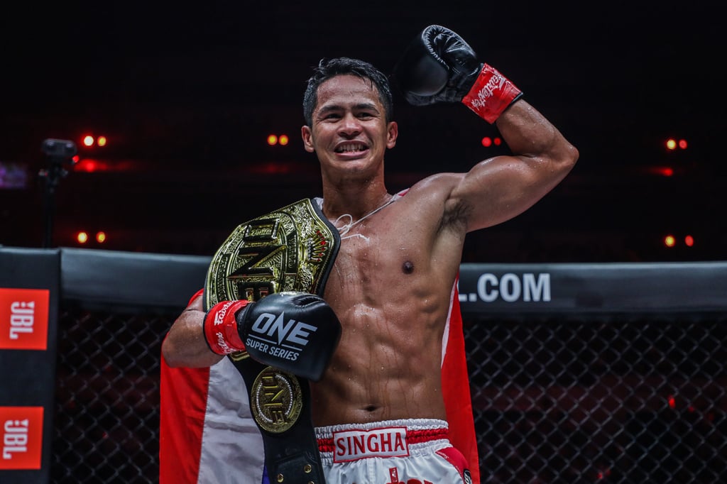 Superbon celebrates after beating Marat Grigorian to retain his featherweight kickboxing title at ONE X in Singapore.