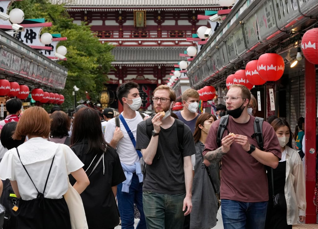 Foreign tourists walk through a street in Asakusa, downtown Tokyo, last week. Photo: EPA-EFE