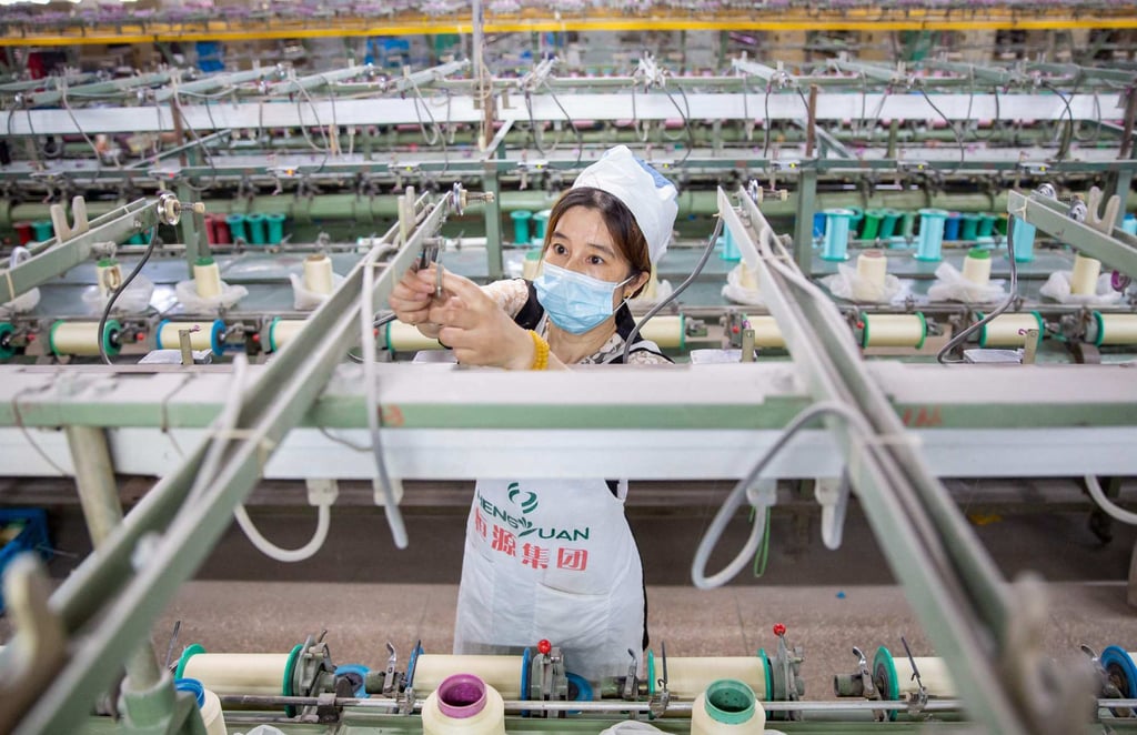 A worker produces silk products for export at a textile factory in Nantong, in China’s eastern Jiangsu province on June 15, 2022. Photo: AFP A worker produces silk products for export at a textile factory in Nantong, in China’s eastern Jiangsu province on June 15, 2022. Photo: AFP