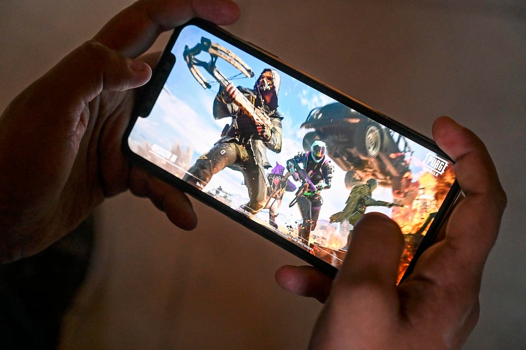 In this photo taken November 20, 2020, a smartphone user plays Tencent’s PUBG mobile game. Photo: AFP In this photo taken November 20, 2020, a smartphone user plays Tencent’s PUBG mobile game. Photo: AFP
