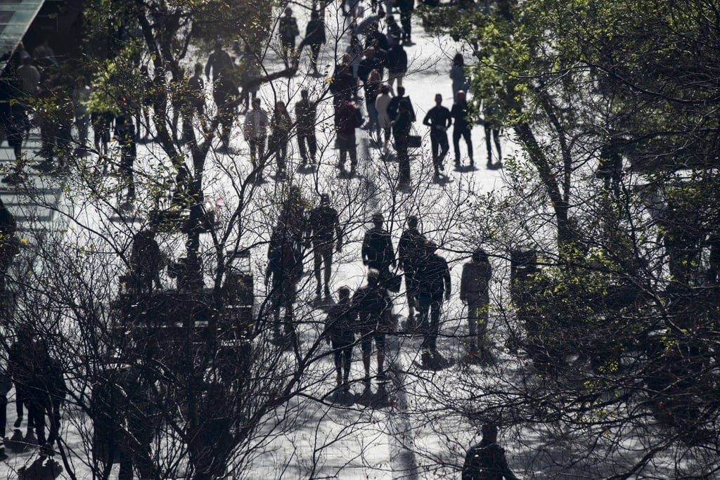 People walk through a shopping area of Sydney, Australia. The picturesque town of Stanwell Park near Sydney is on the front line of the battle against the bin-raiding cockatoos. Photo: Bloomberg