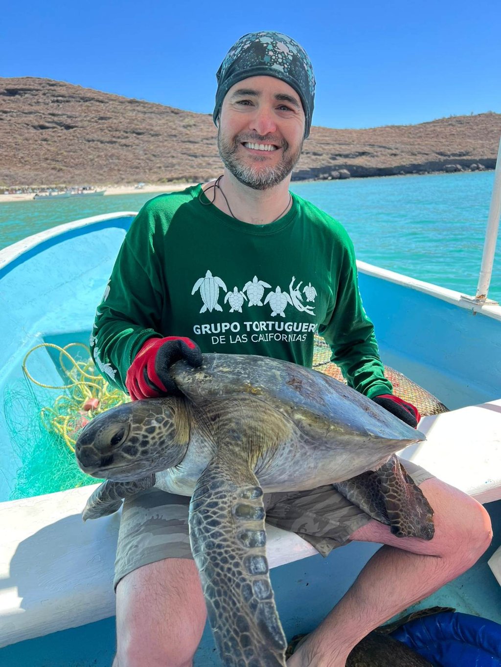 Arizona State University assistant research professor Jesse Senko holds a green turtle in Mexico. Photo: Handout