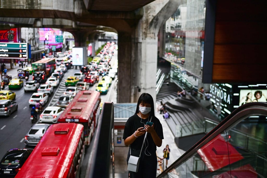 A woman goes up an escalator to access the ‘BTS Skytrain’ in Bangkok. Thailand is looking to boost economic activity by making it easier for high-net-worth individuals to live and work in the country. Photo: AFP