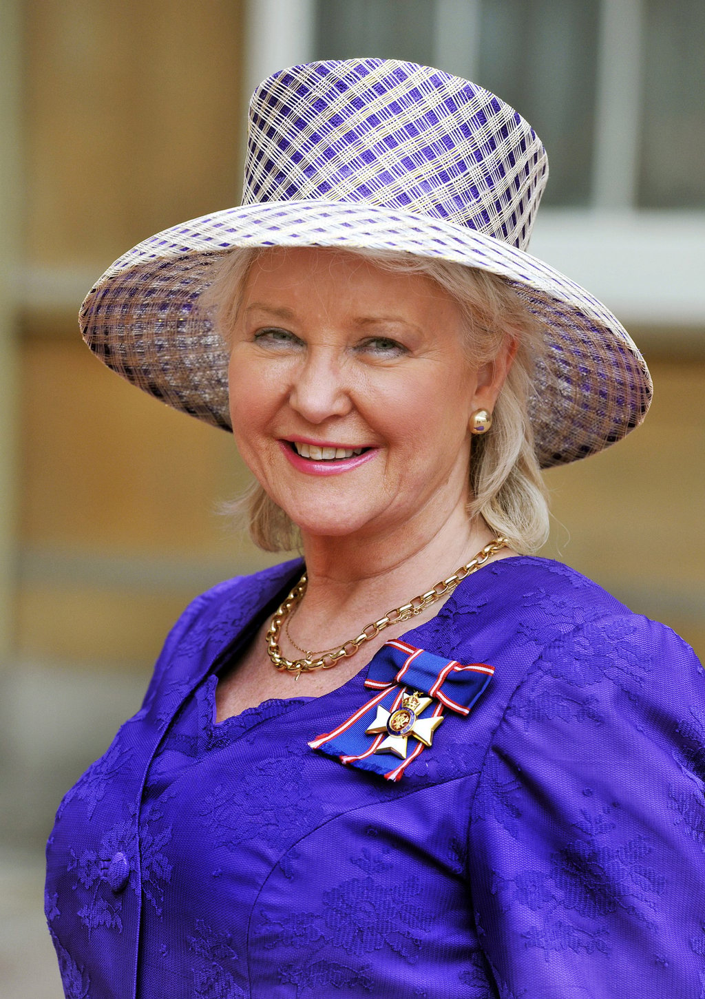 Angela Kelly, the personal dresser to Queen Elizabeth, proudly wears her Royal Victorian Order medal, after it was presented to her by the queen, at the Investiture ceremony at Buckingham Palace, in November 2012, in London, England. Photo: Getty Images