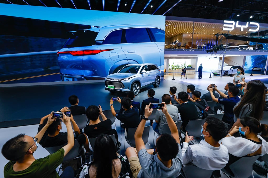 Visitors and members of the media take photos of a new BYD model at last month’s Chengdu Motor Show. Photo: Xinhua