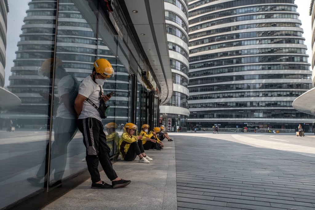 Delivery workers for Meituan wait for orders in Beijing, China, June 3, 2022. Photo: Bloomberg