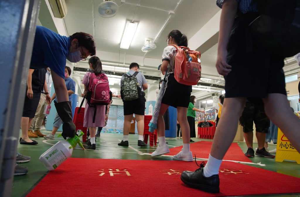 Staff disinfect the carpet at the entrance to S.K.H. Holy Spirit Primary School, Sha Tin, as students return after a four-month suspension caused by the coronavirus. Photo: Winson Wong Staff disinfect the carpet at the entrance to S.K.H. Holy Spirit Primary School, Sha Tin, as students return after a four-month suspension caused by the coronavirus. Photo: Winson Wong