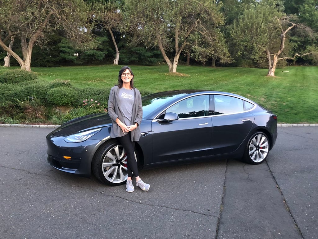 Cathie Wood and Tesla Model 3. She famously predicted that Tesla would be a US$3 trillion company. Photo: @CathieDWood/Twitter